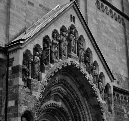 Vintage-style photograph capturing the intricate details of Ják Church's façade in Hungary.