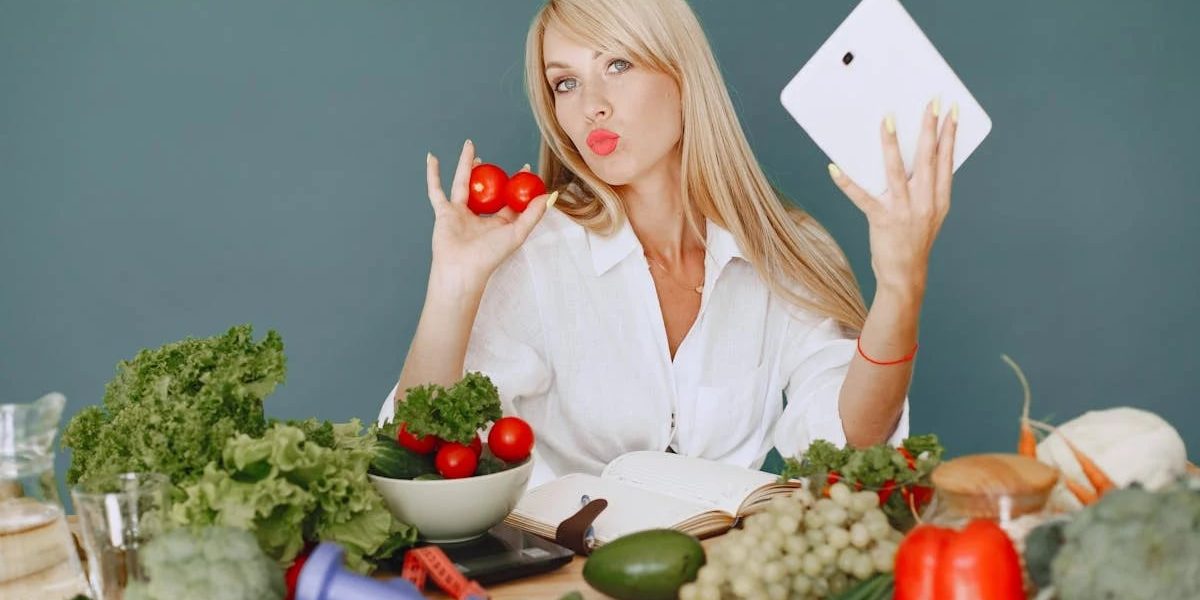 Vlogger promoting healthy eating with fresh vegetables on the table.